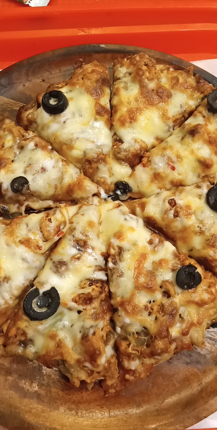 Homemade BBQ chicken pizza with barbecue sauce, mozzarella, chicken, red onion and cilantro